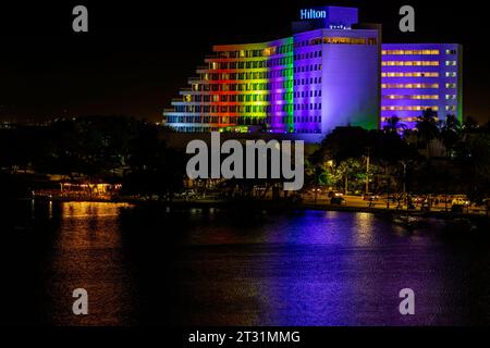 Cartagena de Indias, Colombia - January 17, 2023: Night view of the Hilton hotel illuminated with the LGBT colors in the El Laguito neighborhood Stock Photo