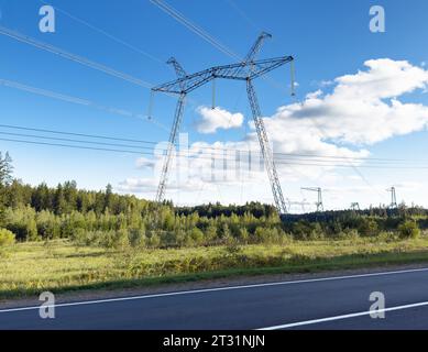 Electricity tower, mast. Electric energy transmission in field near road Stock Photo