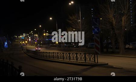 Street with police car. Concept. Night street with patrolling police car. Street at night with flashing lights of police car Stock Photo
