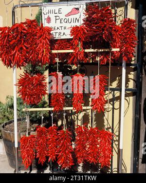 United States. New Mexico. Santa Fe. Strings of hot red chilli peppers. Stock Photo