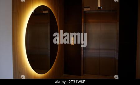 View inside of an entrance hall. Stock footage. Interior of the lobby with elevator, toilets and glowing mirror. Stock Photo