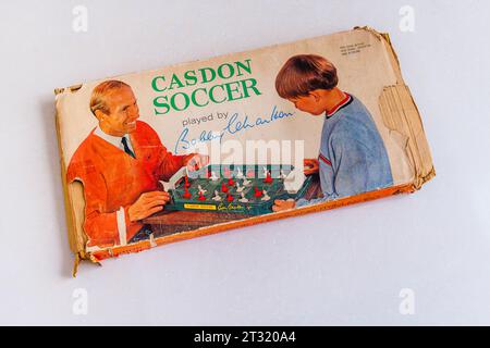 A vintage children's table-top football game, Casdon Soccer played by Bobby Charlton, in a battered box dating from the mid 1960s Stock Photo