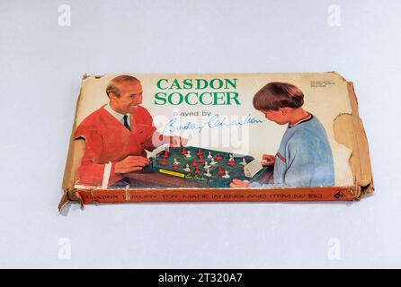 A vintage children's table-top football game, Casdon Soccer played by Bobby Charlton, in a battered box dating from the mid 1960s Stock Photo