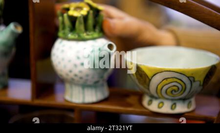 Painting dishes with bright colors. Art. Drawings on light dishes that are painted for the exhibition. Stock Photo