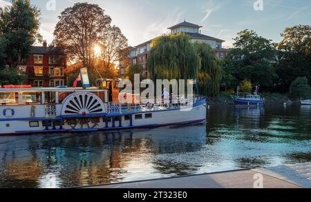 Richmond Upon Thames, London - September 17, 2022: View of the River Thames and a large boat floating at sunset with tourists enjoying the trip Stock Photo