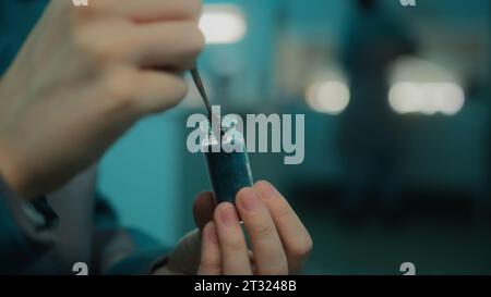 Close-up of taking chemical mixture. Stock footage. Chemist takes little loose mixture with spoon. Bulk chemical mixture in jar in laboratory Stock Photo