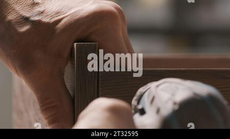 Painstaking work. Creative. Strong strong male people who assemble furniture in parts and special details. Stock Photo