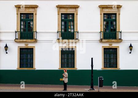 Tunja, Colombia - January 4, 2023: Young man standing in front of Palacio de la Torre, Boyaca government building Stock Photo