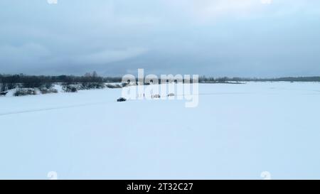 Bending winter ice track and driving cars during race. Clip. Winter sports race outdoors, drifting on ice. Stock Photo