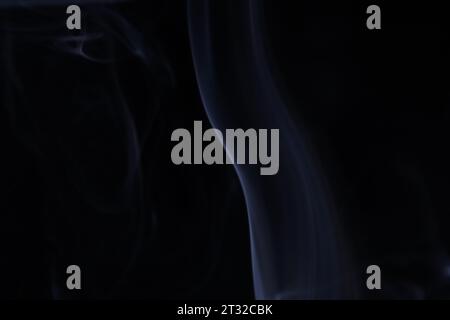 Cold silver smoke on a dark background, colourful abstract, white fog, minimalistic background, detailed smoke shapes Stock Photo