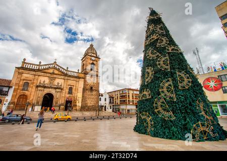 Tunja, Colombia - January 4, 2023: Woman walks towards the Cathedral of the city Stock Photo