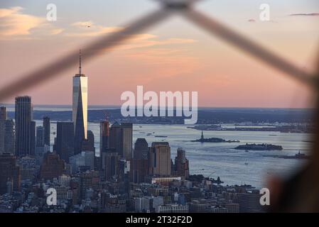 The One World Trade Center and the Statue of Liberty in New York City Skyline, seen from the Empire State Building at Dusk Stock Photo