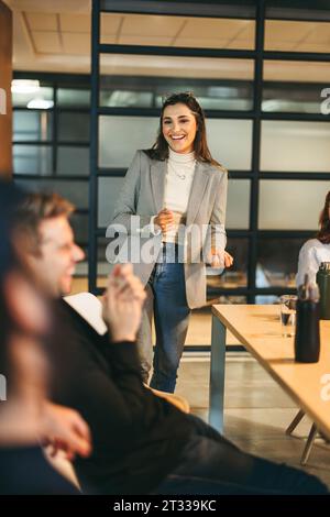 Happy business people in a modern office engage in a lively, brainstorming meeting. With a focus on creativity and teamwork, they discuss project mana Stock Photo