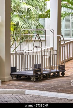 Hotel luggage cart, luggage stroller in front of luxury hotel or Bellman luggage cart. Stock Photo