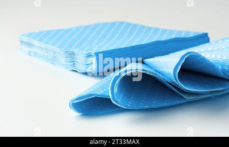 Stack of blue dotted paper napkins isolated on white Stock Photo