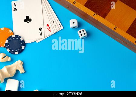 Playing cards, chips and dice on blue backgorund Stock Photo