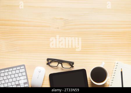 wood desk office with laptop, smartphone and other work supplies with cup of coffee. Top view with copy space for input the text. Designer workspace o Stock Photo