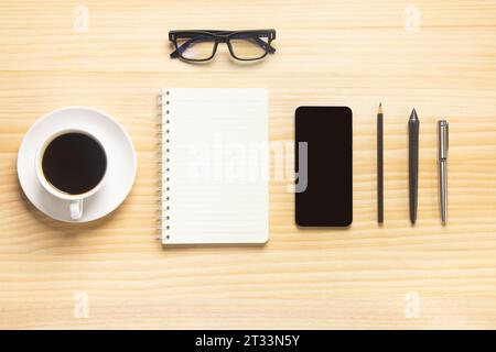 wood desk office with laptop, smartphone and other work supplies with cup of coffee. Top view with copy space for input the text. Designer workspace o Stock Photo