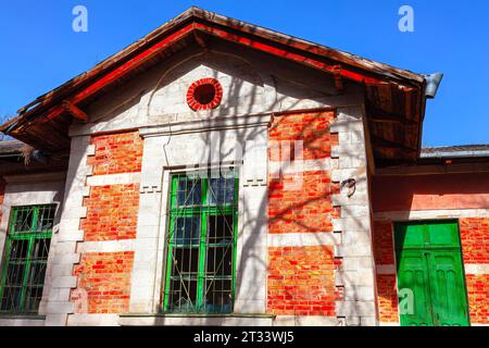 Old abandoned building with red brick wall on blue sky background Stock Photo