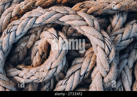 Old worn frayed ship ropes as background, selective focus Stock Photo