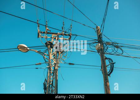 Street light with electricity utility pole and electrical wires, low angle view Stock Photo