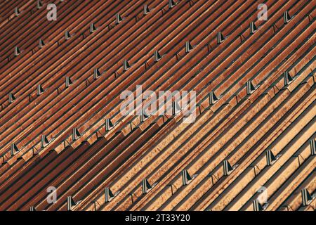 Snow guards or stoppers on house roof as abstract background Stock Photo