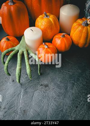 Halloween background with many pumpkins and candles decoration on black wood table with copy space, vertical style. Halloween traditional celebration Stock Photo