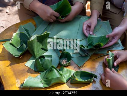 The process of making containers made from banana leaves, an environmentally friendly concept. Stock Photo