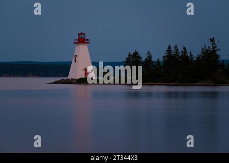 Lighthouse on an island in a lake Stock Photo