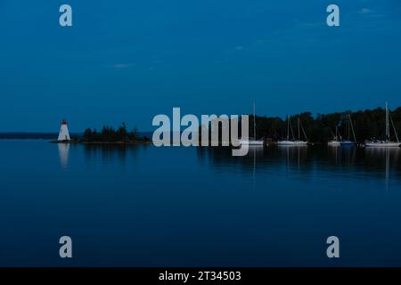 Lighthouse on an island in the evening Stock Photo