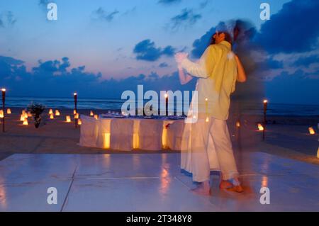 Couple dancing on their wedding night on the beach on Isla Mujeres, Mexico Stock Photo