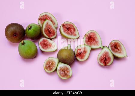 Whole and sliced figs on a pink background Stock Photo