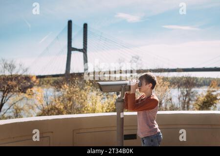 Person looking through binoculars over Mississippi River in Cape Stock Photo