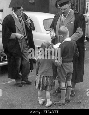 Jimmy Edwards signs autograph for children during break in filming on location, 1950's Stock Photo