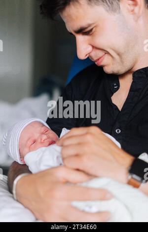 Portrait of an uncle with his one day old baby nephew Stock Photo