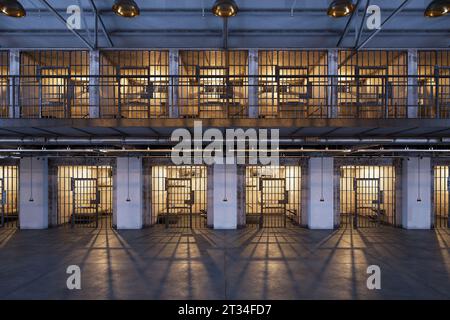 A prison hallway showcasing two floors and rows of cells. Hallway of the modern loft jail. A block with a zone of single person cells, dedicated to th Stock Photo