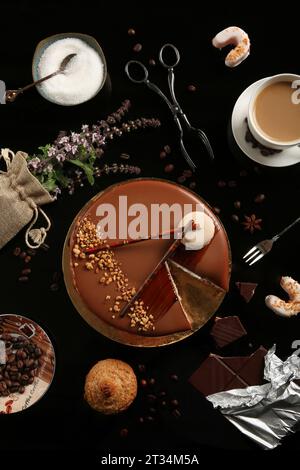 Flat lay composition with different desserts on black background. Top view of cookies, cake, coffee and chocolate. Stock Photo