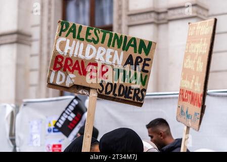 Placard referencing children and IDF soldiers at a Free Palestine protest in London following the escalation of the conflict in Israel and Gaza Stock Photo