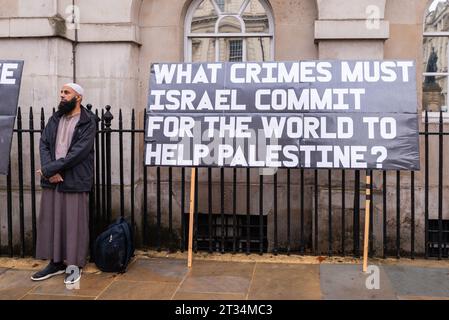 Large placard at a Free Palestine protest in London following the escalation of the conflict in Israel and Gaza. What crimes must Israel commit Stock Photo