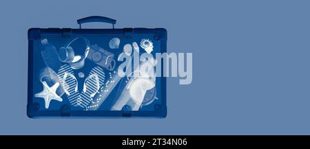 X-ray scan of a suitcase with travel accessories inside, summer vacations concept, copy space Stock Photo