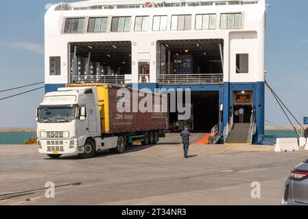 Port of Heraklion, Crete, Greece. 01.10.2023.  Greek ferry with commercial truck loading the stern ramp. Seaport activities in the port of Heraklion Stock Photo