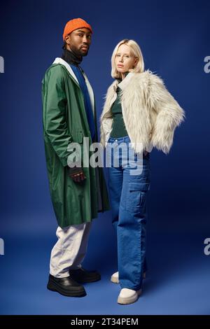 stylish interracial couple, attractive woman in faux fur jacket and handsome african american man Stock Photo