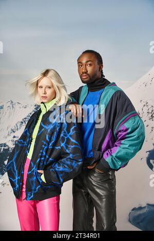 attractive young interracial couple in warm stylish attire looking at camera, winter concept Stock Photo