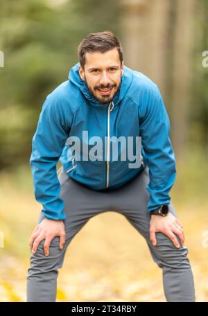 Portrait of a good looking young sportsman resting and looking at the camera. Stock Photo