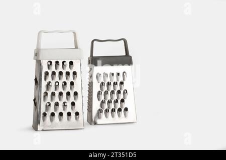 Two stainless steel graters on a white background with copy space Stock Photo