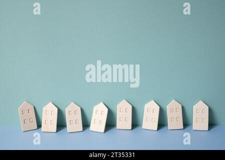 Miniature wood model house on mint blue background. rental, buy, real estate concept Stock Photo