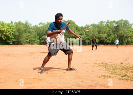 Auroville, India - August 2023: Playing Gilli Danda, the traditional indian game that is believed to be the origin of games such cricket and baseball Stock Photo