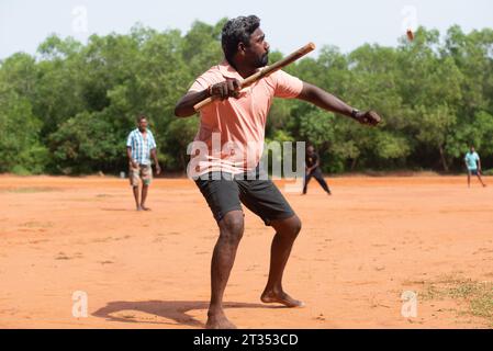 Auroville, India - August 2023: Playing Gilli Danda, the traditional indian game that is believed to be the origin of games such cricket and baseball Stock Photo