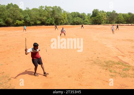 Auroville, India - August 2023: Playing Gilli Danda, the traditional indian game that is believed to be the origin of games such cricket and baseball Stock Photo