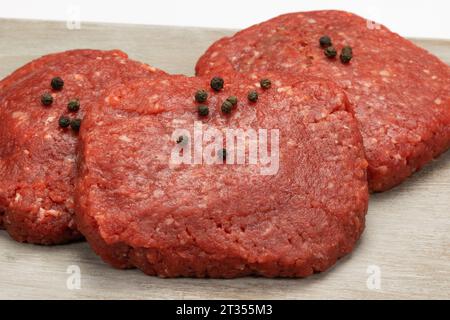 Raw beef minced steaks, close-up, isolated on a white background Stock Photo